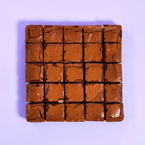 Classic Brownie from Crumbs & Doilies, perfectly baked with a shiny crackly top and fudgy edges.
